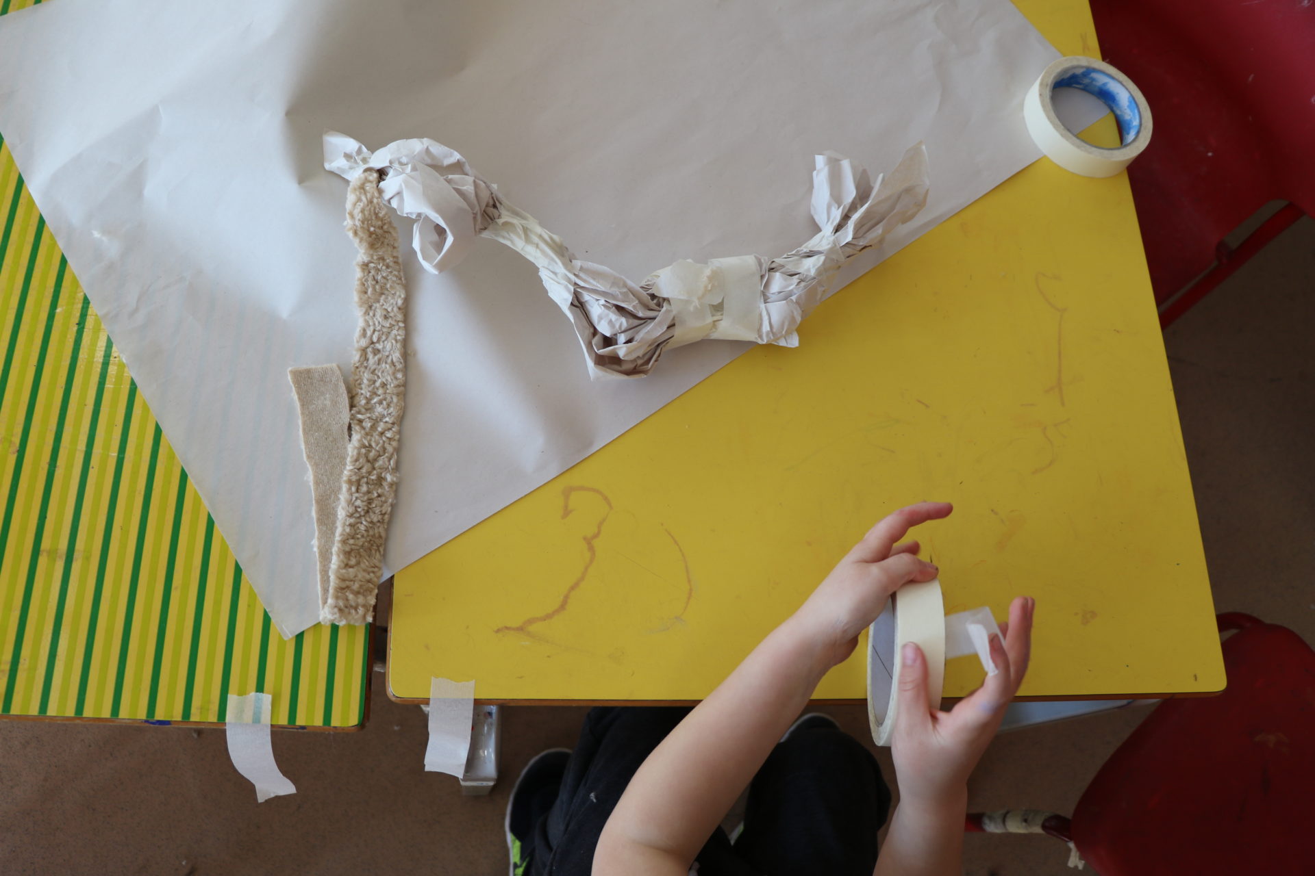 Hands, paper, yellow table