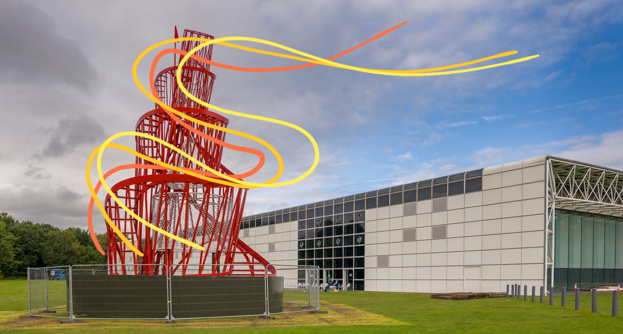 Large red sculpture in the shape of a twisting tower with waves of orange and yellow surrounding it