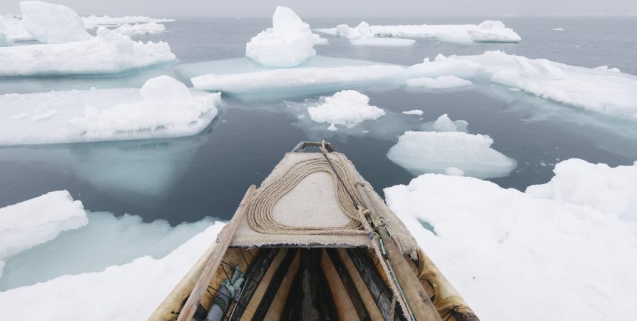 A photograph of a boat in the Arctic