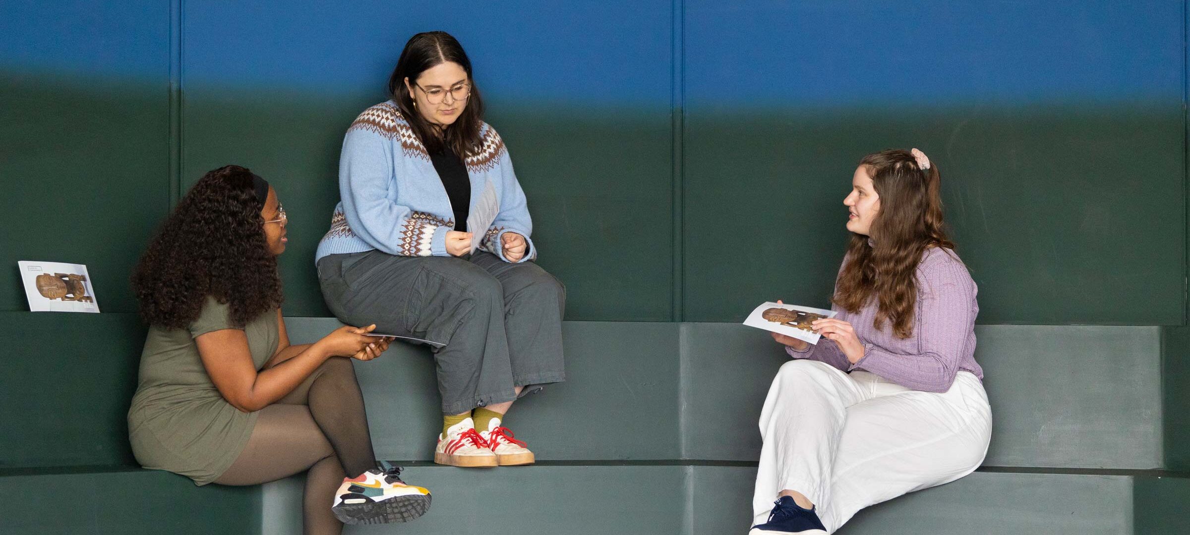 Three visitors sitting inside the Space for Dialogue at the Sainsbury Centre, Norwich.