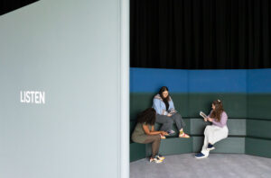 Three visitors sitting inside the Space for Dialogue at the Sainsbury Centre, Norwich.